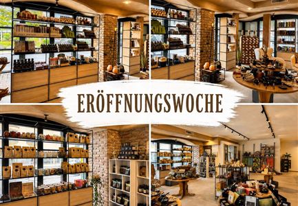 Das Bild zeigt einen modern gestalteten Laden mit verschiedenen Regalen voller Produkte. In der Mitte steht der Text "Eröffnungswoche".