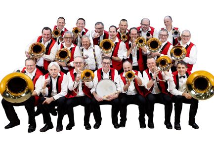 A large group of musicians in traditional attire stands in a room. They are holding instruments and smiling at the camera.