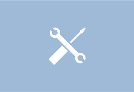 A simple symbol with a wrench and a screwdriver on a blue background. It represents tools or craftsmanship.