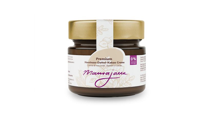 Ein Glas mit Premium Haselnuss-Datteln-Kakao Creme. Es hat einen goldenen Deckel und ein elegantes Etikett.