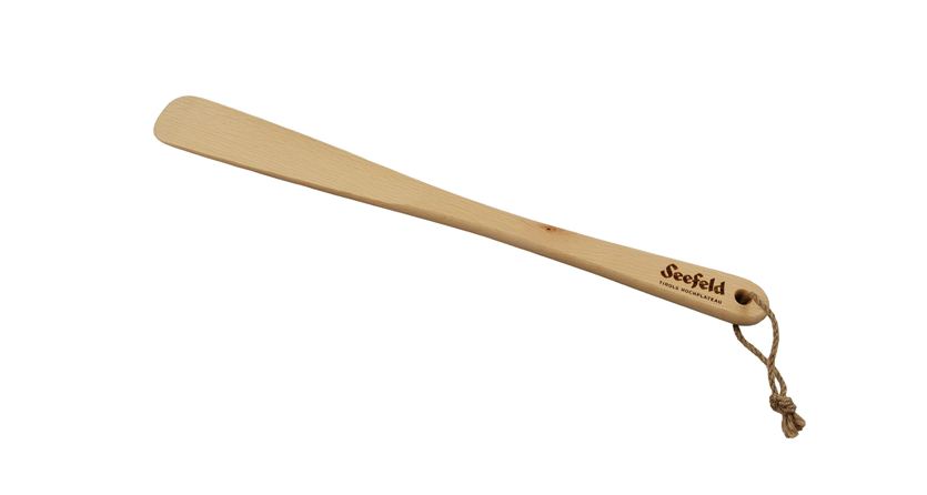 A simple wooden shoehorn with a loop. It bears the inscription "Seefeld".
