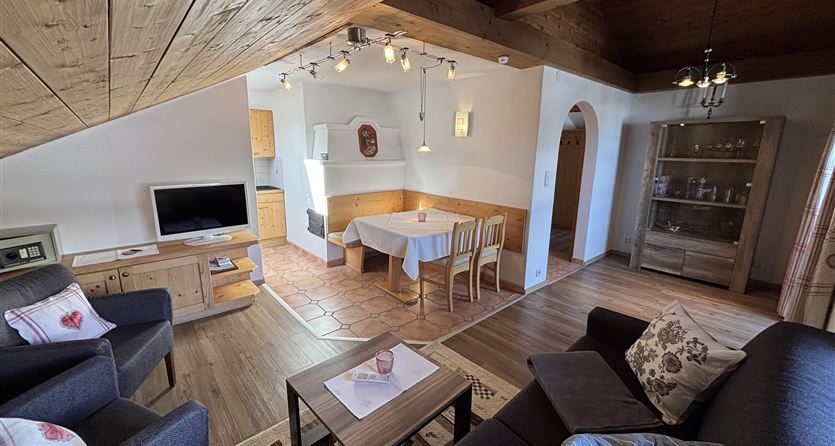 A cozy living area with a sofa and a table that can be used for meals. The modern decor creates an inviting atmosphere.