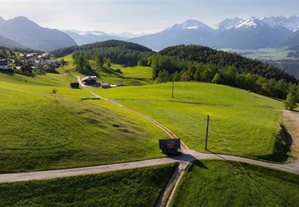 Reith Wiesenweg im Frühling - Drohnenaufnahme strahlend grüne Wiese mit Blick zum Inntal.jpg